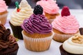 Colorful cupcakes with different Tastes. Small beautifull cakes on white table top. Close up