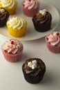 Colorful cupcakes on a white background. Pink, yellow and chocolate cupcakes. Party food. Sweet dessert or breakfast. Party,