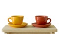 Colorful cups on wooden table Royalty Free Stock Photo