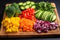 colorful cut vegetables on a wooden chopping board Royalty Free Stock Photo