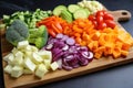 colorful cut vegetables on a wooden chopping board Royalty Free Stock Photo