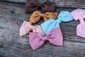 Colorful and cute ribbon bows for girls , on dark wooden background