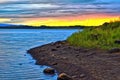 Colorful dawn over the blue waters of a forest lake