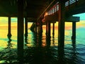 colorful dawn over the ocean under a fishing pier in Florida Royalty Free Stock Photo