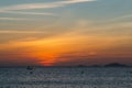 Colorful dawn, sunset on a calm sea. Silhouette of a fishing boat on the horizon.  Beautiful sea background, landscape. Fiery Royalty Free Stock Photo