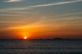 Colorful dawn, sunset on a calm sea. Silhouette of a fishing boat on the horizon.  Beautiful sea background, landscape. Fiery Royalty Free Stock Photo