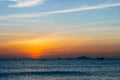 Colorful dawn, sunset on a calm sea. Silhouette of a fishing boat on the horizon.  Beautiful sea background, landscape. Fiery Royalty Free Stock Photo