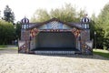 Colorful decorated bandstand in traditional Russian style in the park. Sunny summer view.