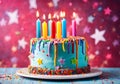 Colorful decorated birthday cake with lit colored candles.