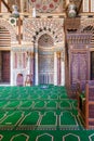 Marble wall with engraved Mihrab, and wooden Minbar, at Mamluk era Mosque of Sultan al Muayyad, Old Cairo, Egypt Royalty Free Stock Photo