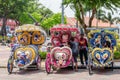 The colorful decorated rickshaws are parking in Dutch Square Malacca waiting for customers.