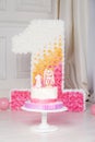 Colorful decoration of a first year birthday cake. Decorated number 1 for a first birthday