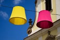 Decorative colorful canvas lamp shades supended on steel wire above public street Royalty Free Stock Photo