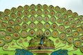 Colorful Decorative Plates with Peacock Motifs on Green Backdrop Royalty Free Stock Photo