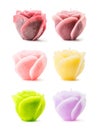 Colorful decorative rose-shaped candles over white