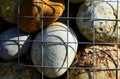Colorful decorative smooth river stone closeup in galvanized wire mesh cage Royalty Free Stock Photo