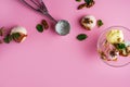 Colorful delicious ice cream on a pink background, with spices, mint leaves