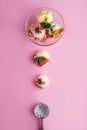 Colorful delicious ice cream on a pink background, with spices, mint leaves