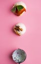 Colorful delicious ice cream on a pink background, with spices, mint leaves