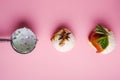 Colorful delicious ice cream on a pink background, with spices, mint leaves