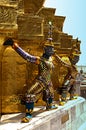 Colorful demon statues surrounding the base of a chedi. Royalty Free Stock Photo