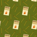 Pattern design featuring matchboxes and matches on a green background Royalty Free Stock Photo