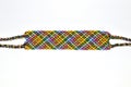 Colorful designer unique friendship bracelet handmade of threads with bright pattern isolated on white background