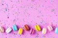 Colorful dessert macaron or macaroon on pink punchy background top view. Flat lay Royalty Free Stock Photo