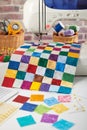 Colorful detail of quilt sewn from square pieces on sewing machine, quilting and sewing accessories Royalty Free Stock Photo