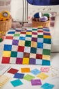 Colorful detail of quilt sewn from square pieces on sewing machine, quilting and sewing accessories Royalty Free Stock Photo