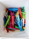 Heap of colorful clothespins are lying in a box Royalty Free Stock Photo