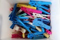 Heap of colorful clothespins are lying in a box Royalty Free Stock Photo