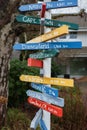 Colorful direction arrow signs on wooden pole. Direction to different places of the world indicated in a street sign Royalty Free Stock Photo