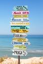 Colorful directions signs on the beach to different places of the world Travel concept Royalty Free Stock Photo