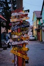 Colorful directions signs on the Old Town Zemun to different places of the world. A pedestrian street with cobblestones