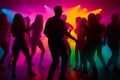 Colorful disco party scene with black silhouettes of people dancing against a vibrant neon-lit background with disco balls and Royalty Free Stock Photo