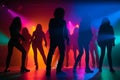 Colorful disco party scene with black silhouettes of people dancing against a vibrant neon-lit background with disco balls and Royalty Free Stock Photo