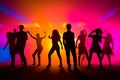 Colorful disco party scene with black silhouettes of people dancing against a vibrant neon-lit background with disco balls and Royalty Free Stock Photo