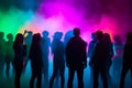 Colorful disco party scene with black silhouettes of people dancing against a vibrant neon-lit background with disco balls and Royalty Free Stock Photo