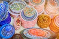 Colorful dishes and bowls with Arabic ornaments in the bazaar shop of Tunisia