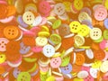 Colorful disorderly small sewing buttons background with dark light