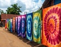 A colorful display of drying Nigerien tie-dye fabrics fluttering in the breeze outdoors Royalty Free Stock Photo