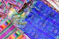Colorful display of handwoven Guatemalan textiles on market stall