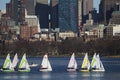 Colorful docked sailboats and Boston Skyline in winter on half frozen Charles River, Massachusetts, USA Royalty Free Stock Photo