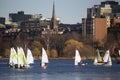 Colorful docked sailboats and Boston Skyline in winter on half frozen Charles River, Massachusetts, USA Royalty Free Stock Photo
