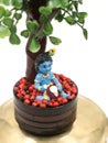 a colorful doll statue of cute baby sri krishna in blue eating butter Royalty Free Stock Photo