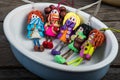 Colorful dolls in a small ceramic ramekin