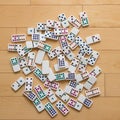 Colorful Dominoes Spread Out on Wooden Floor Royalty Free Stock Photo