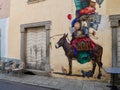 Colorful donkey graffiti on yellow facade in the streets of Corte. Corsica, France.