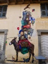 Colorful donkey mural on yellow facade in the streets of Corte. Corsica, France. Vertical.